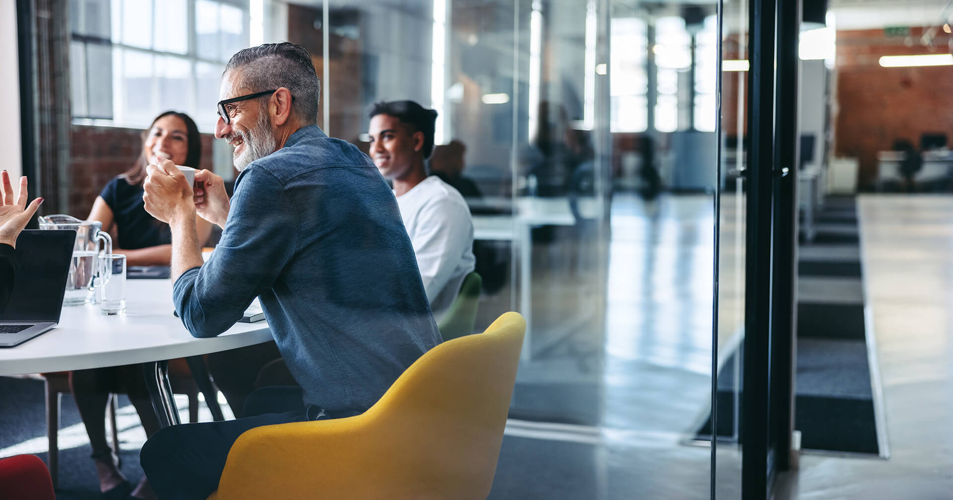 Group of individuals having a casual meeting in a modern office building conference room