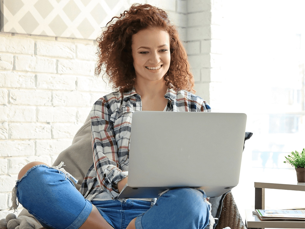 woman on laptop accessing online personal banking tools