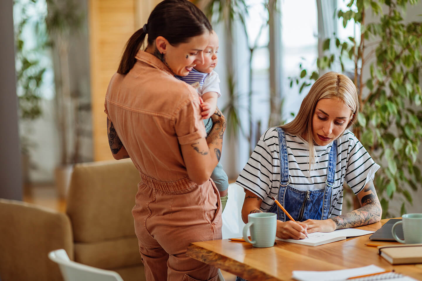 Young family of three around kitchen table discussing savings accounts