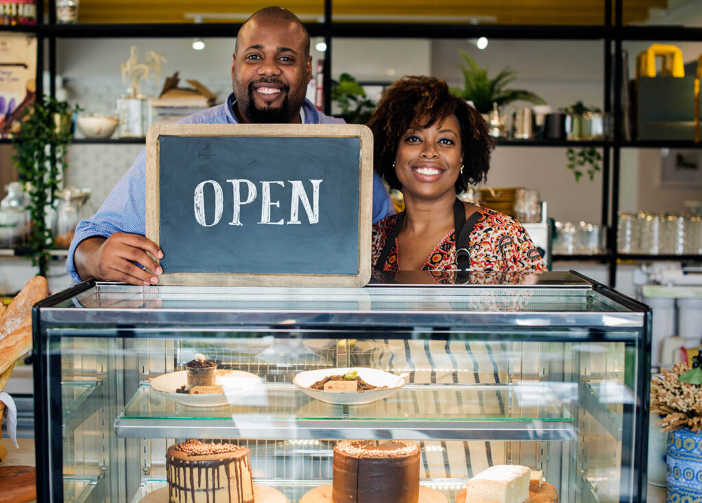 Small business owners in recently opened bakery after applying for a SBA loan
