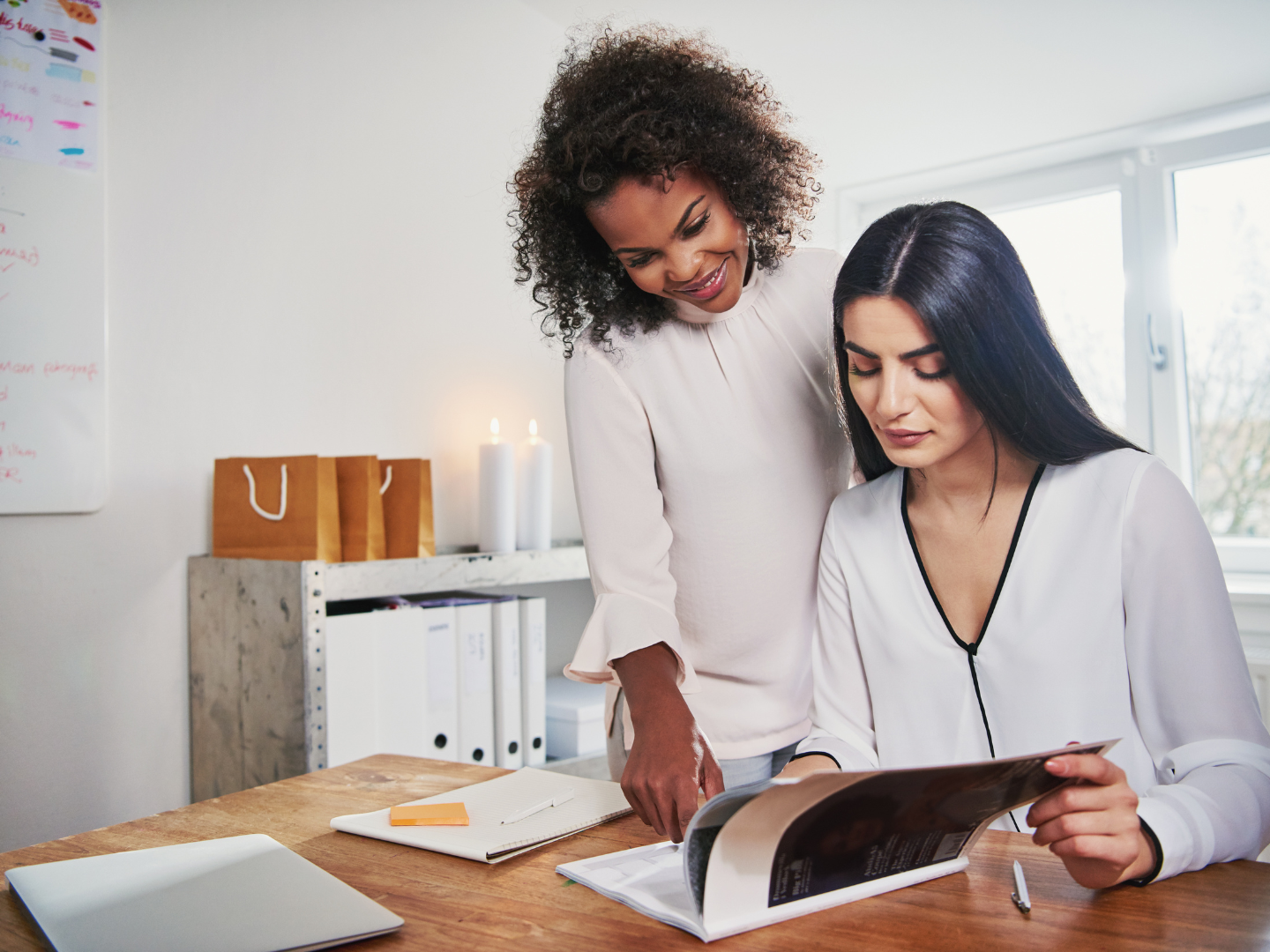 two female owners looking over finances for their new business from their small business bank account