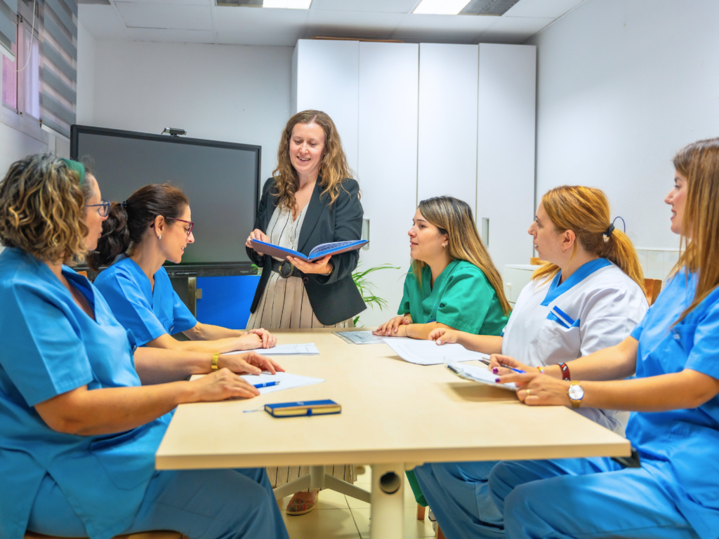 the owner of a home healthcare business shares her plans to expand the practice with her employees during a team meeting