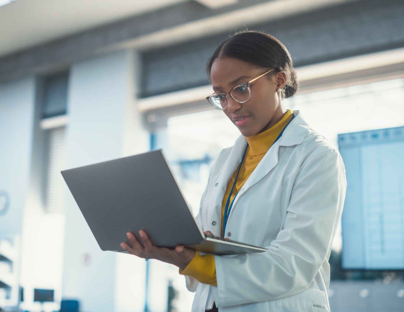 the owner of a pharmaceutical lab reviews her business checking account on her laptop