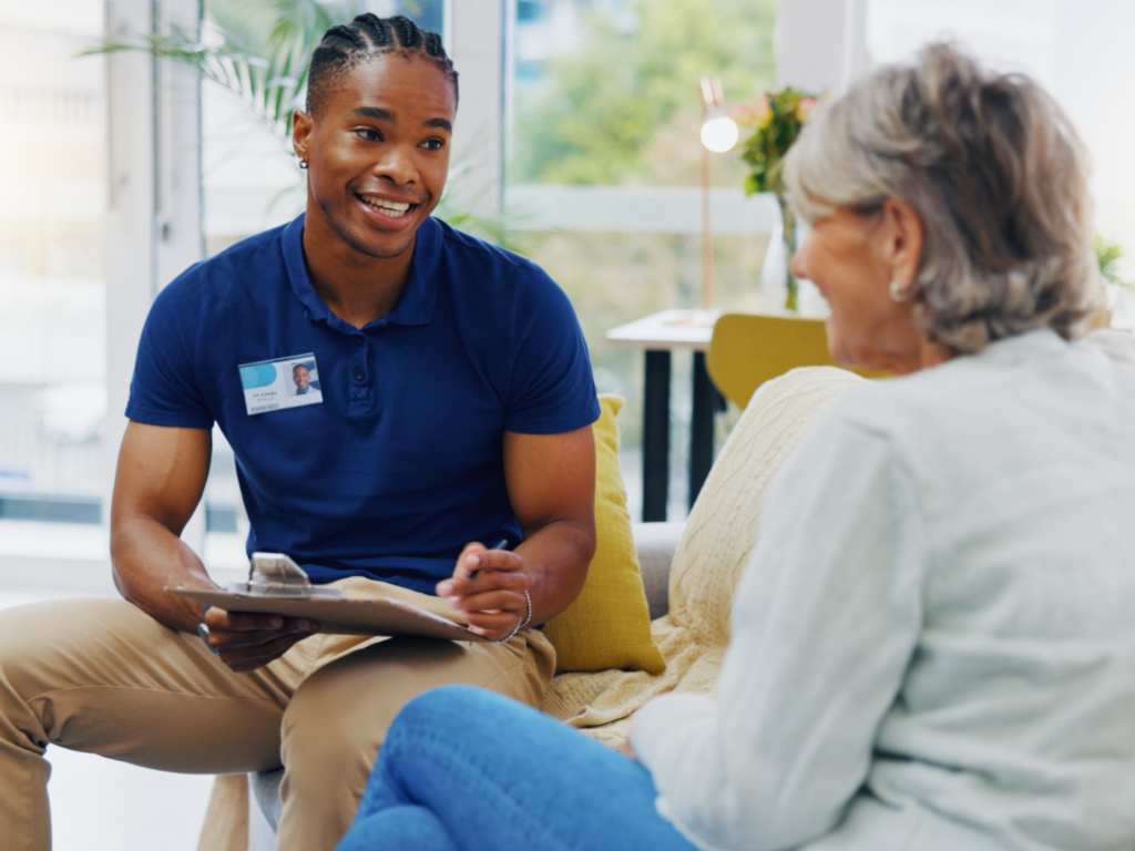 an owner of a home healthcare company in philadelphia sits down to meet with a patient after expanding his practice after reviewing LGBTQ+ small business resources