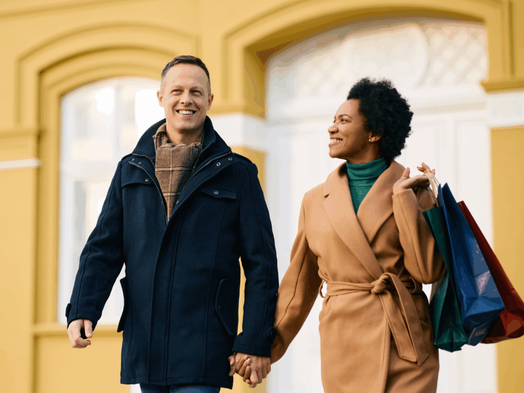 a couple doing their holiday shopping after their holiday savings plan worked for their finances