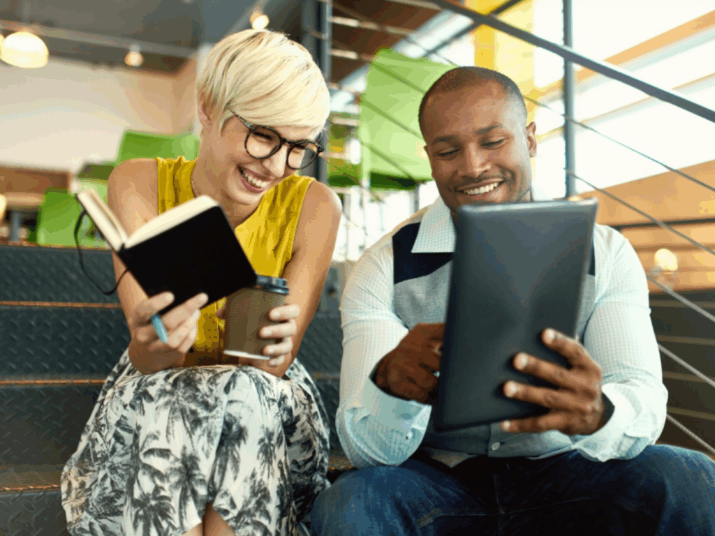 a female and male coworker review options from business banking from quaint oak bank
