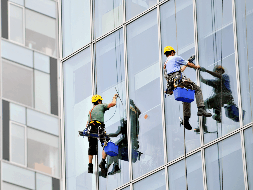 two workers for a window cleaning company who recently received funding with commercial cleaning business loans