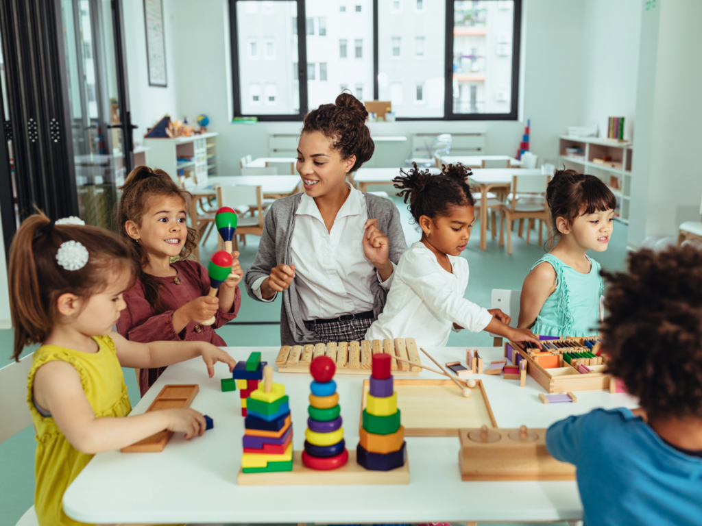 the owner of a daycare teaching kids in a room she expanded her business after learning more about SBA financing for child care business