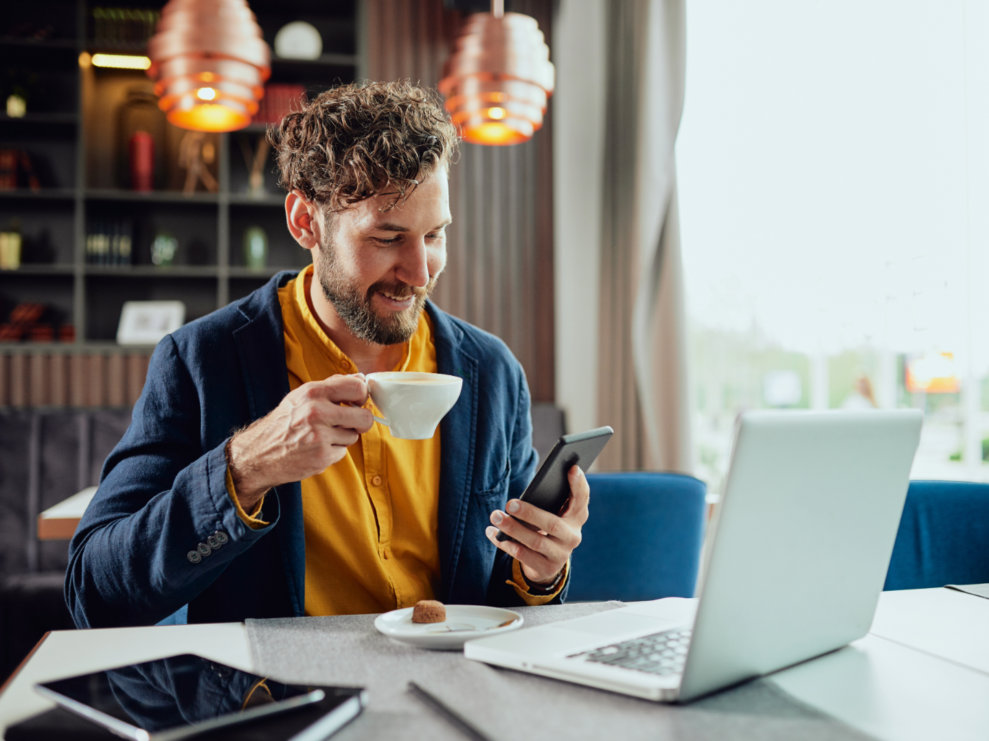 a man reading privacy policies on his phone to make safer cyber security choices