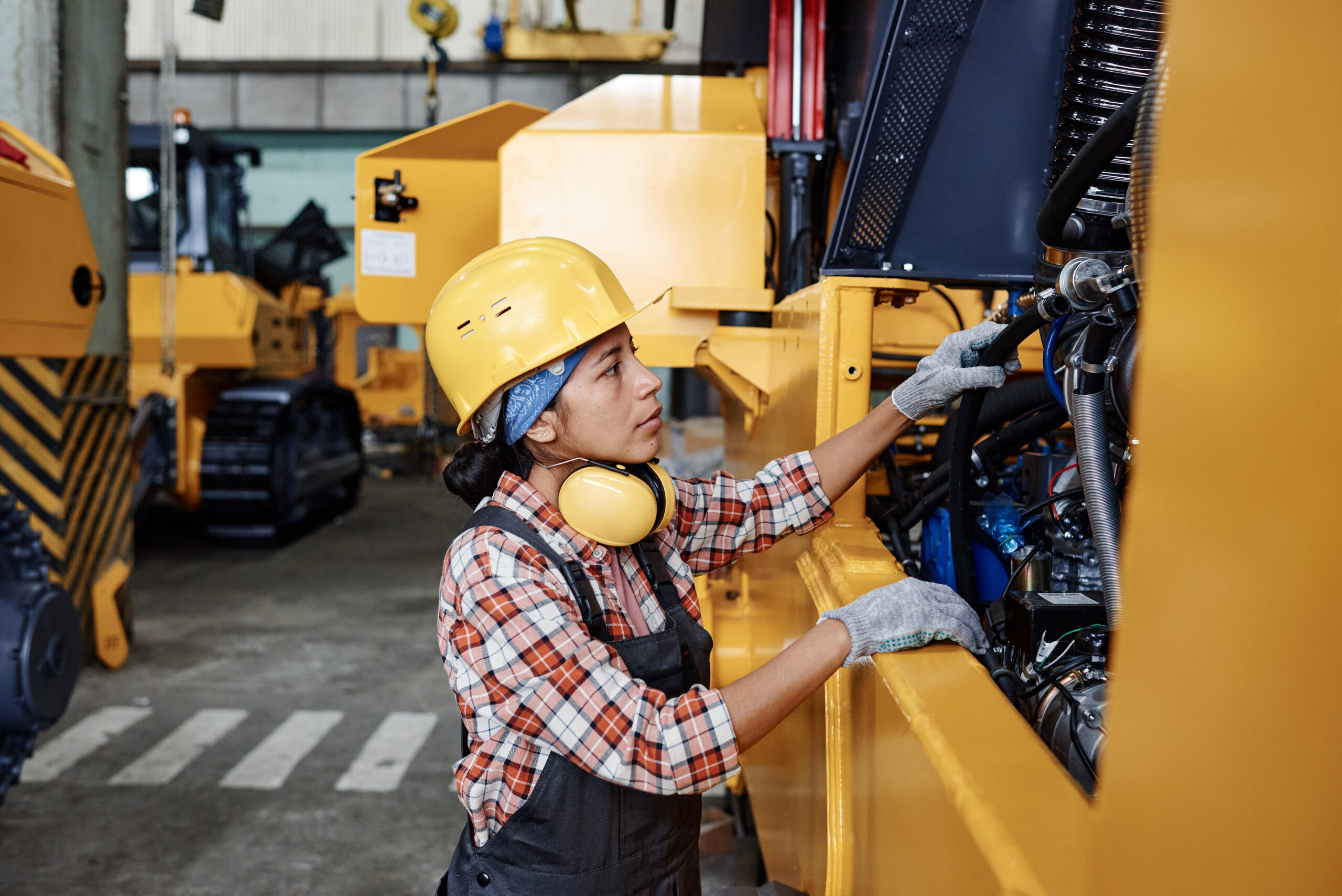 Employee of a business looking at new equipment acquired through SBA 7(a) loans